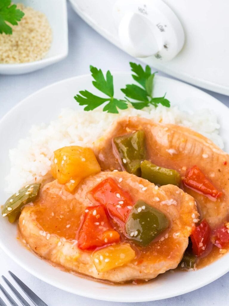 Crockpot sweet and sour pork chops served on a plate.