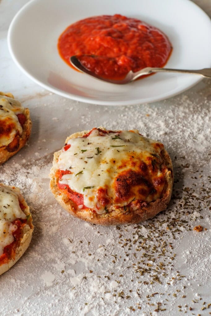 English muffin pizzas with melted cheese and tomato sauce.