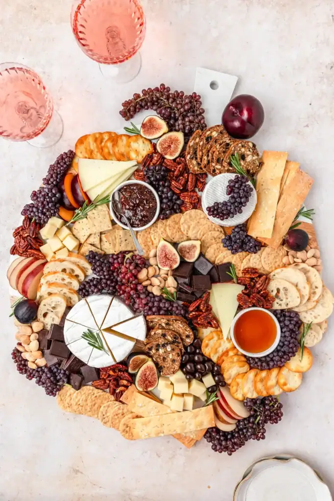 Fall dessert cheeseboard with cheese, crackers, fruit, and nuts.