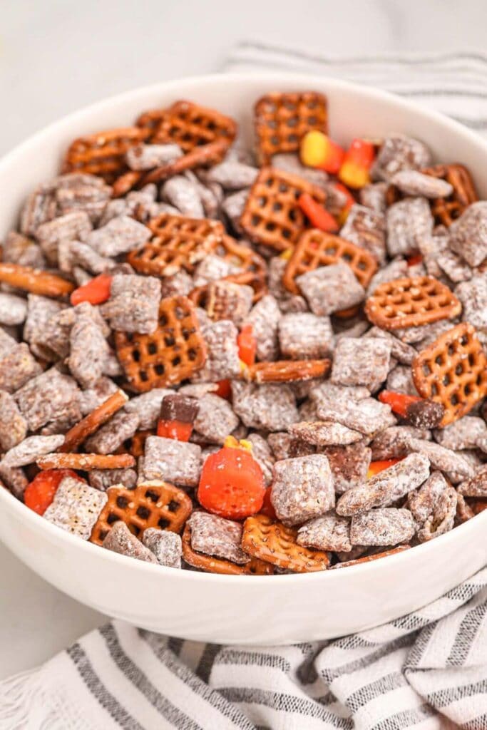 Fall harvest muddy buddies in a bowl.