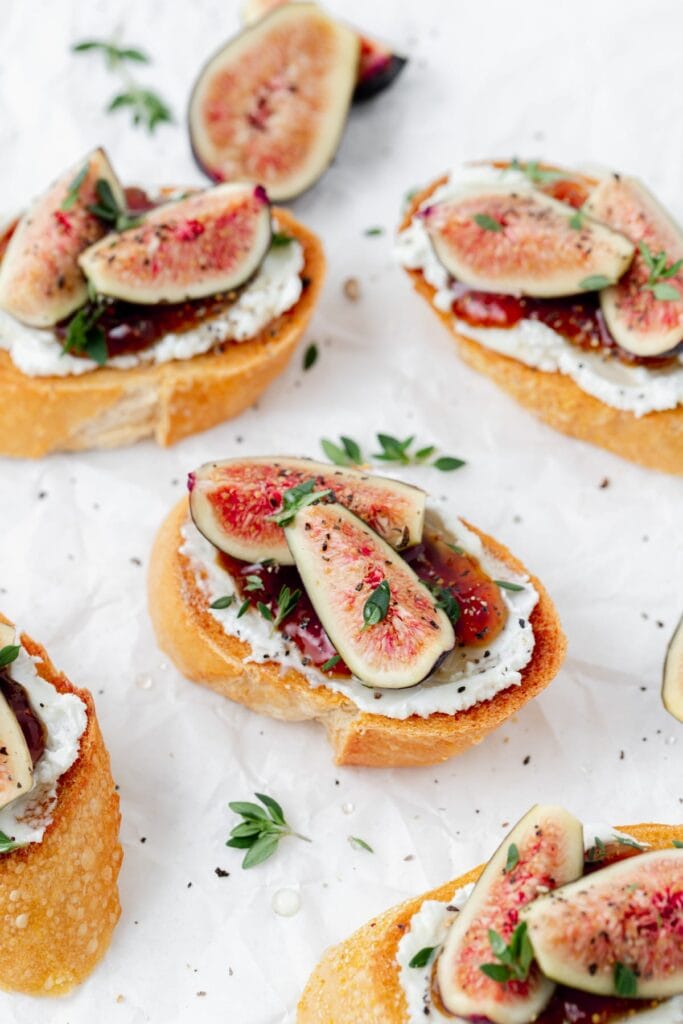 Fig and goat cheese crostini on a plate.