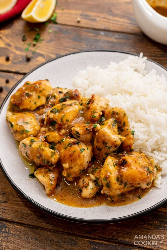 Garlic chicken with parsley on a plate.