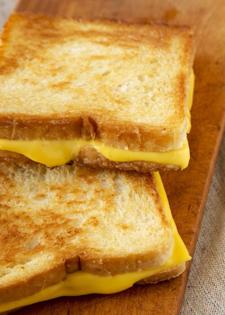Grilled Cheese Sandwich on a rustic wooden board.
