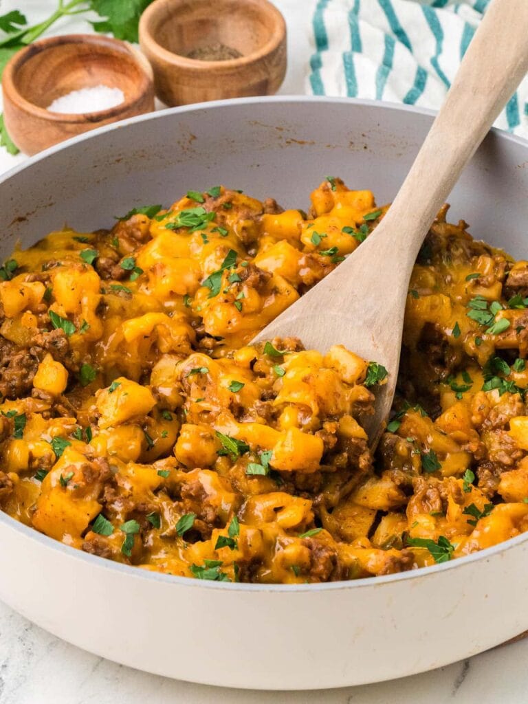 Ground beef and potatoes in a skillet.