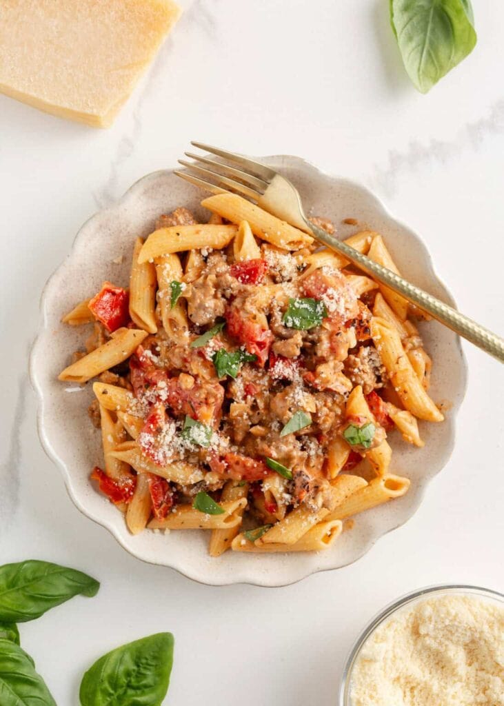 Italian sausage pasta served in a bowl.