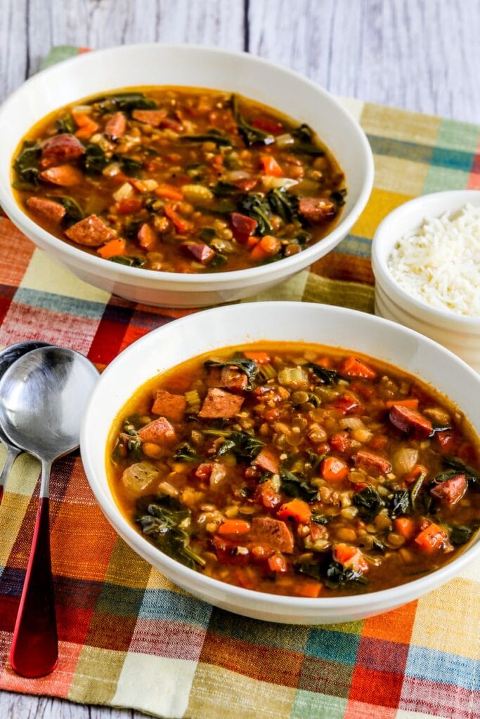 Lentil sausage spinach soup served in a bowl.