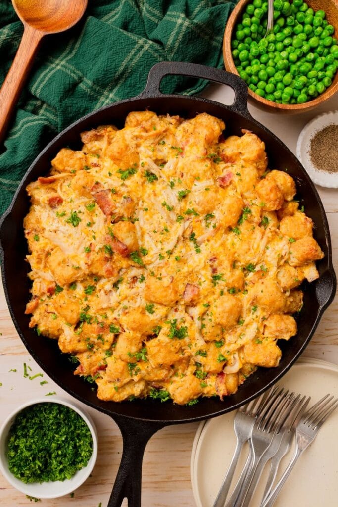 Loaded tater tot chicken casserole in a skillet.