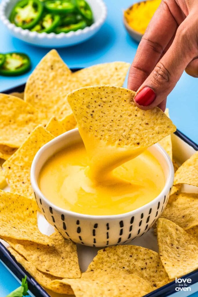 Nacho cheese sauce served with tortilla chips.