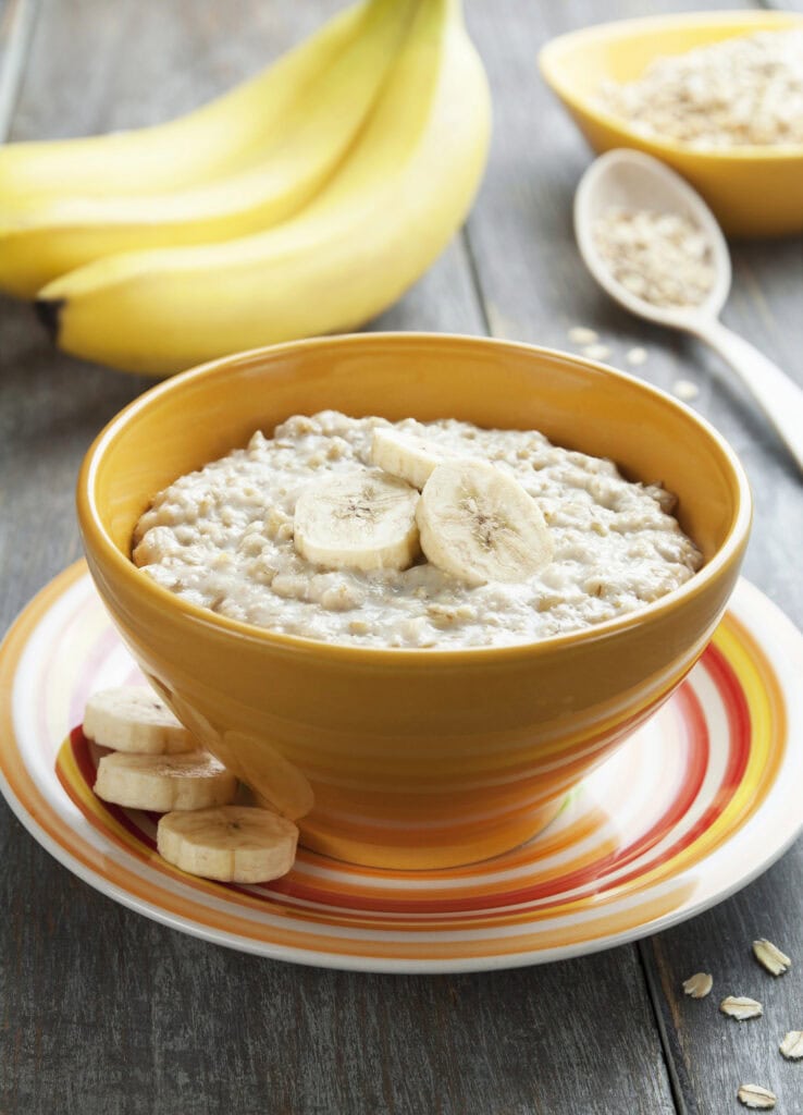 Oatmeal in a bowl topped with banana slices.
