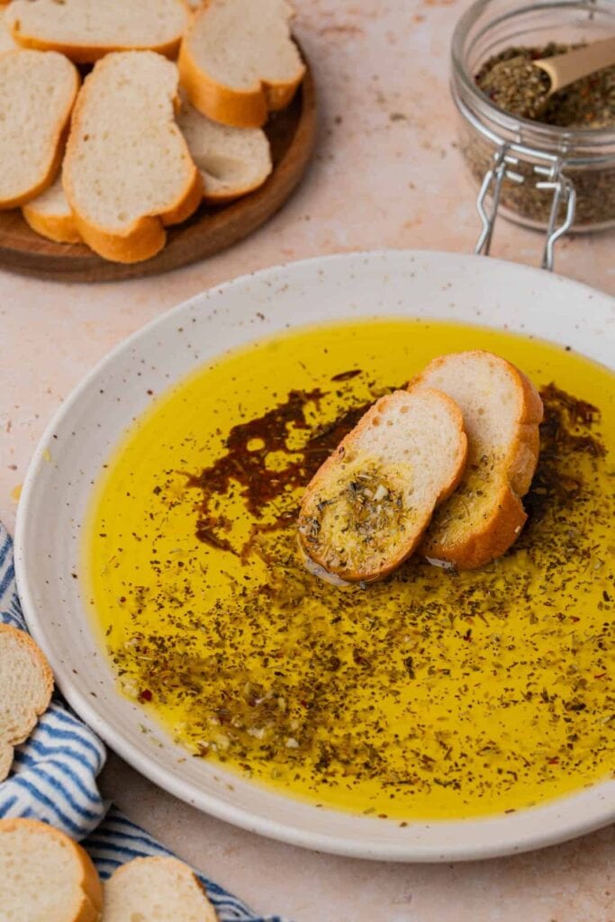 Olive oil dip for bread served on a plate.