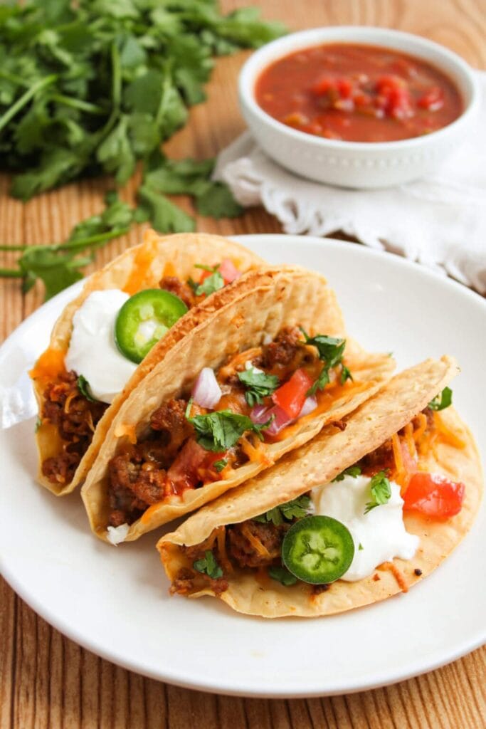 Oven baked beef tacos served on a plate.