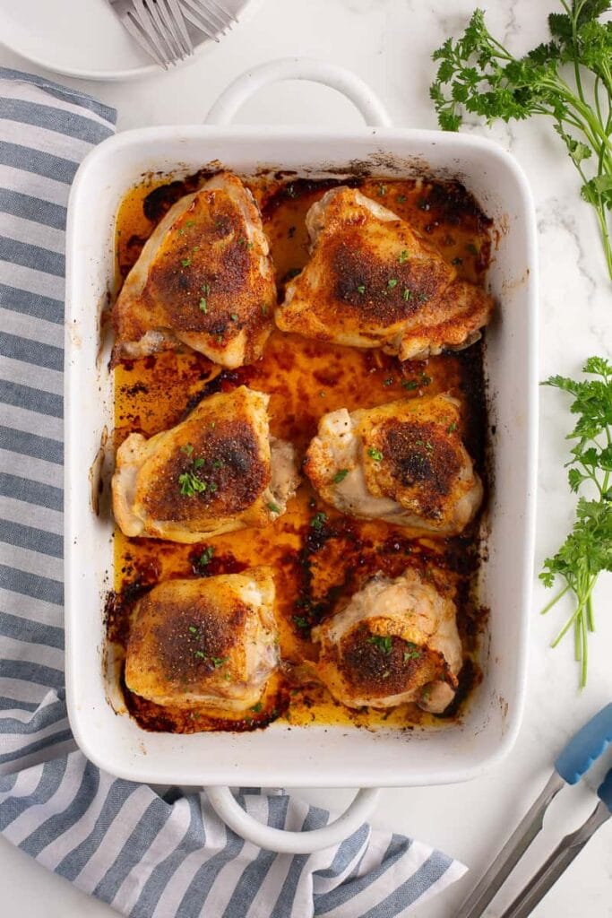 Oven baked chicken thighs in a baking dish.