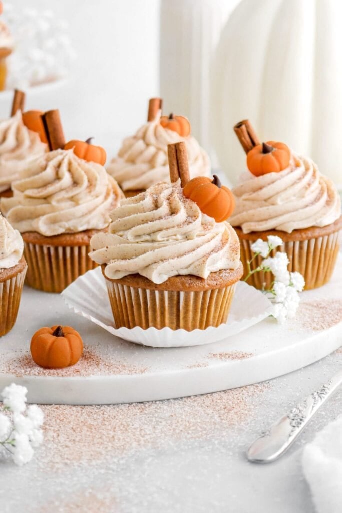 Pumpkin cupcakes with spiced buttercream frosting on a plate.