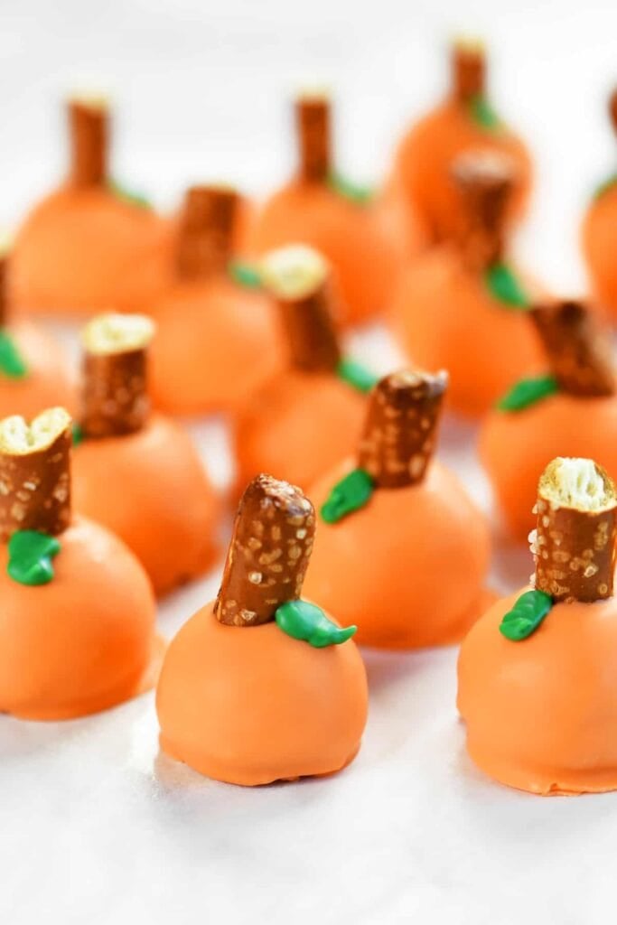 Pumpkin Oreo balls on a plate.