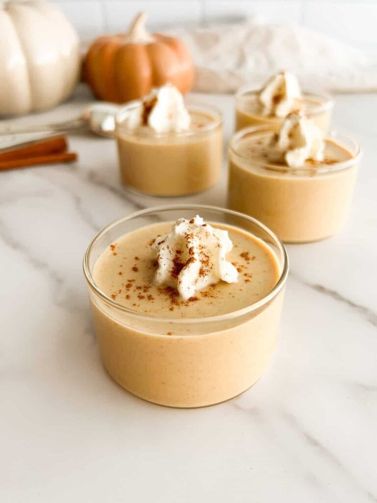 Pumpkin panna cotta topped with whipped cream and cinnamon.