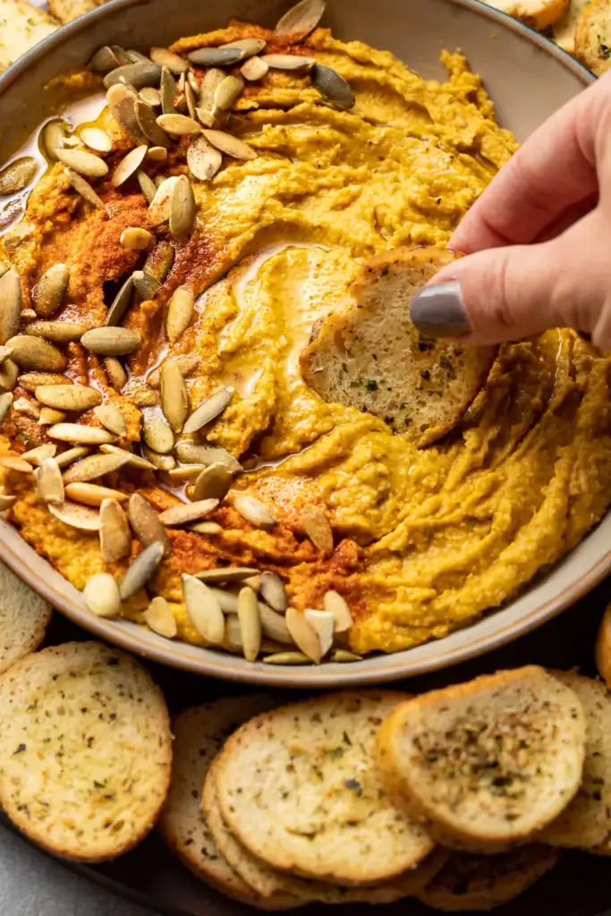 Roasted garlic sage pumpkin hummus in a bowl.