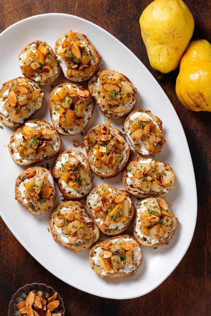 Roasted pear crostini on a plate.