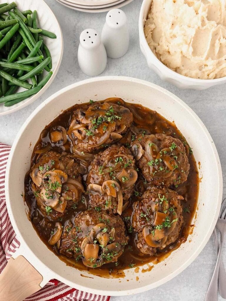 Salisbury steak in a skillet.