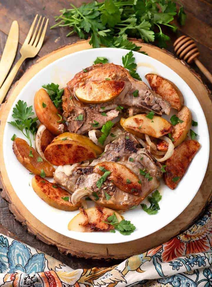 Slow cooker apple cinnamon pork chops served on a plate.