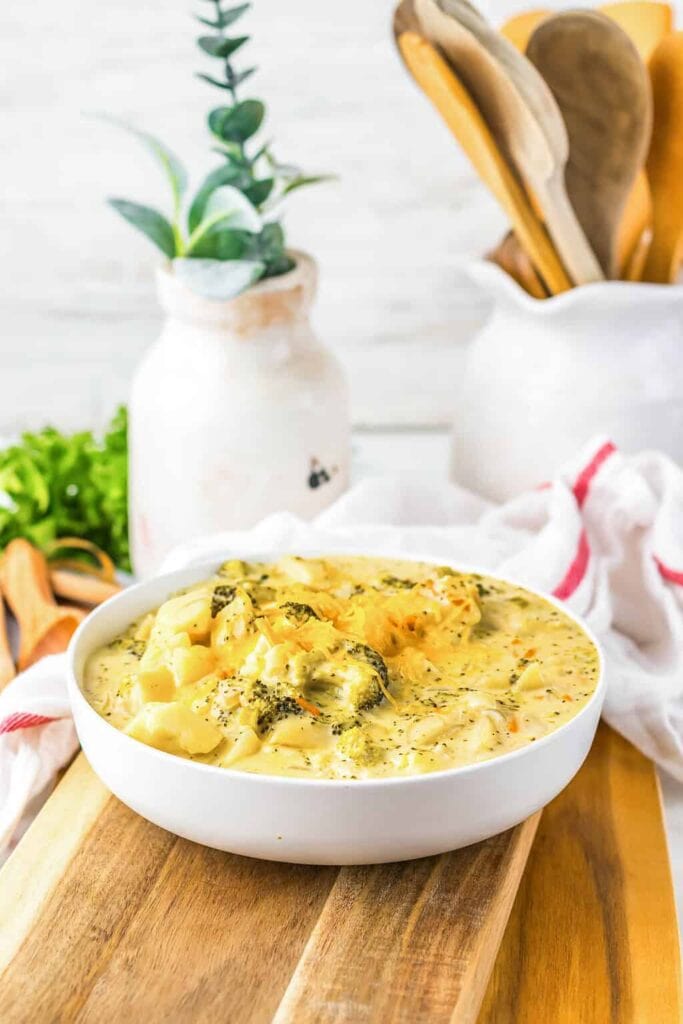 Slow cooker cheesy potato soup with broccoli served in a bowl.
