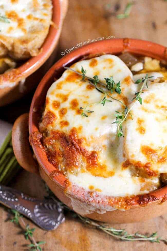 Slow cooker French onion soup topped with melted cheese.