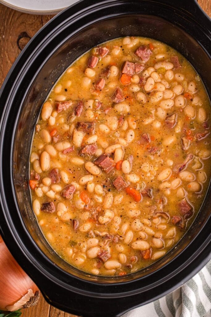Slow cooker ham and bean soup served in a bowl.