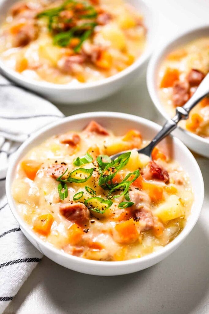 Slow cooker ham and potato soup served in a bowl.