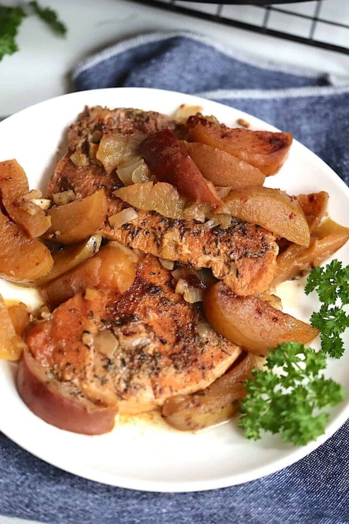 Slow Cooker Pork Chops and Apples served on a plate.