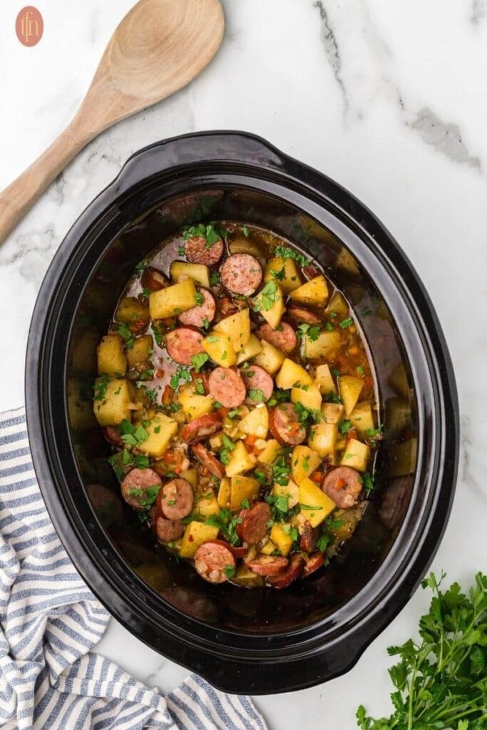 Sausage and potatoes in a crockpot.