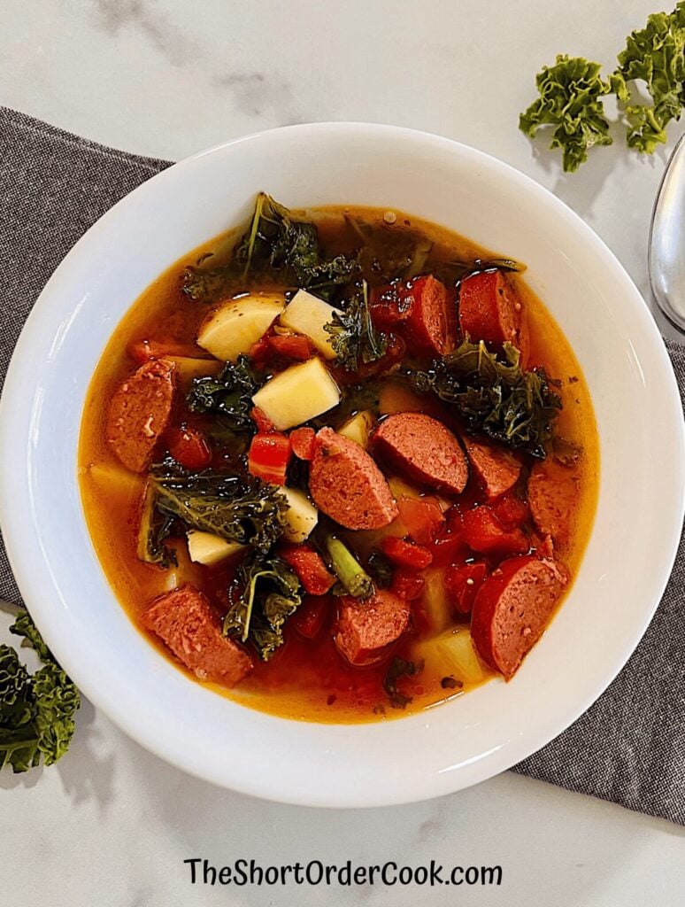 Slow cooker sausage kale soup served in a bowl.