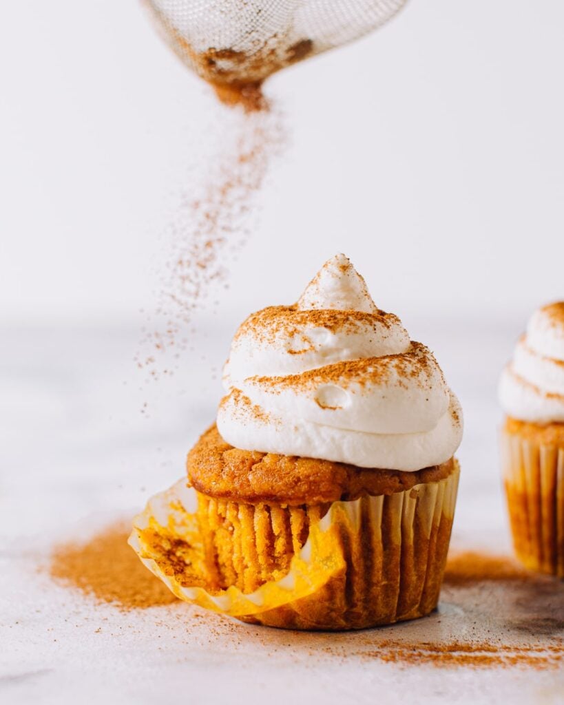 Sweet potato cupcake with marshmallow frosting dusted with cinnamon.