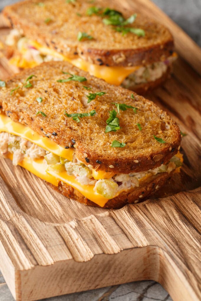 Tuna melt on a wooden board.