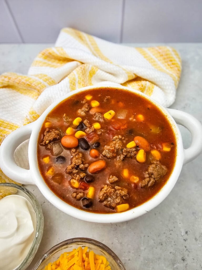 7 Can Taco Soup with Ground Beef served in a white bowl.