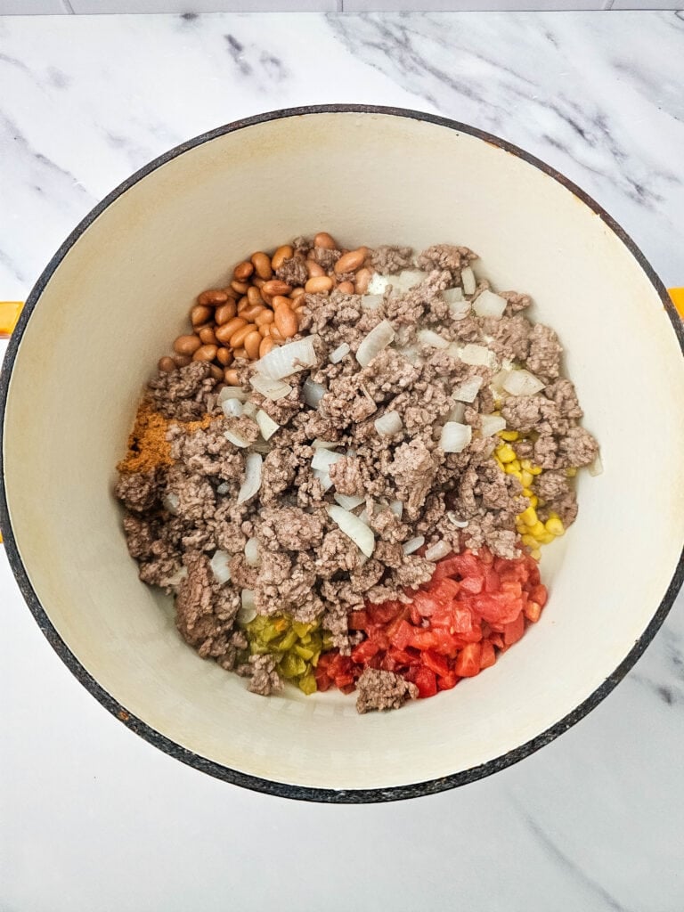 Cooked ground beef and onion added to the pot