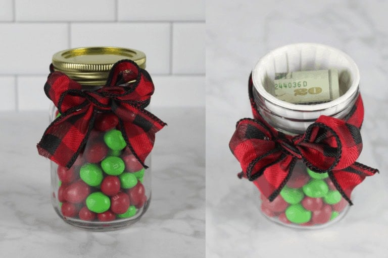 Glass jar with plaid ribbon bow, filled with red and green candies, hiding rolled currency inside lid compartment.