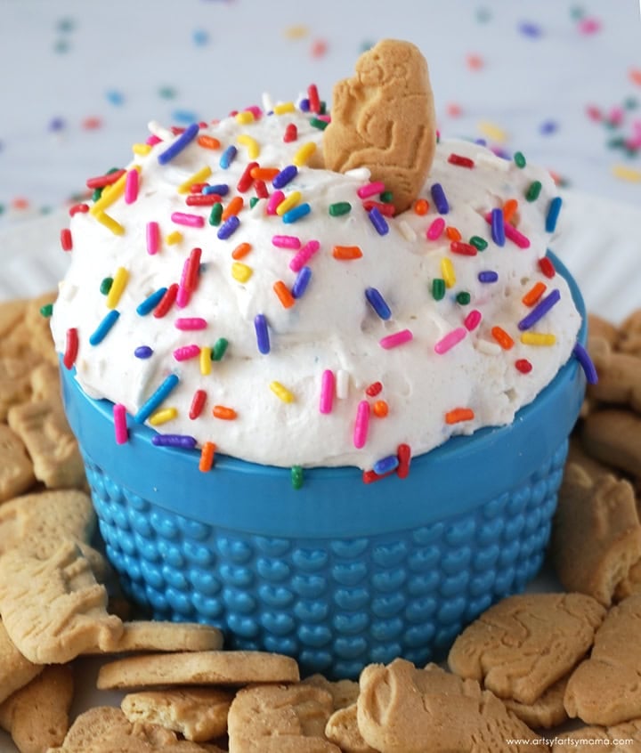 Creamy animal cracker funfetti dip topped with colorful sprinkles.