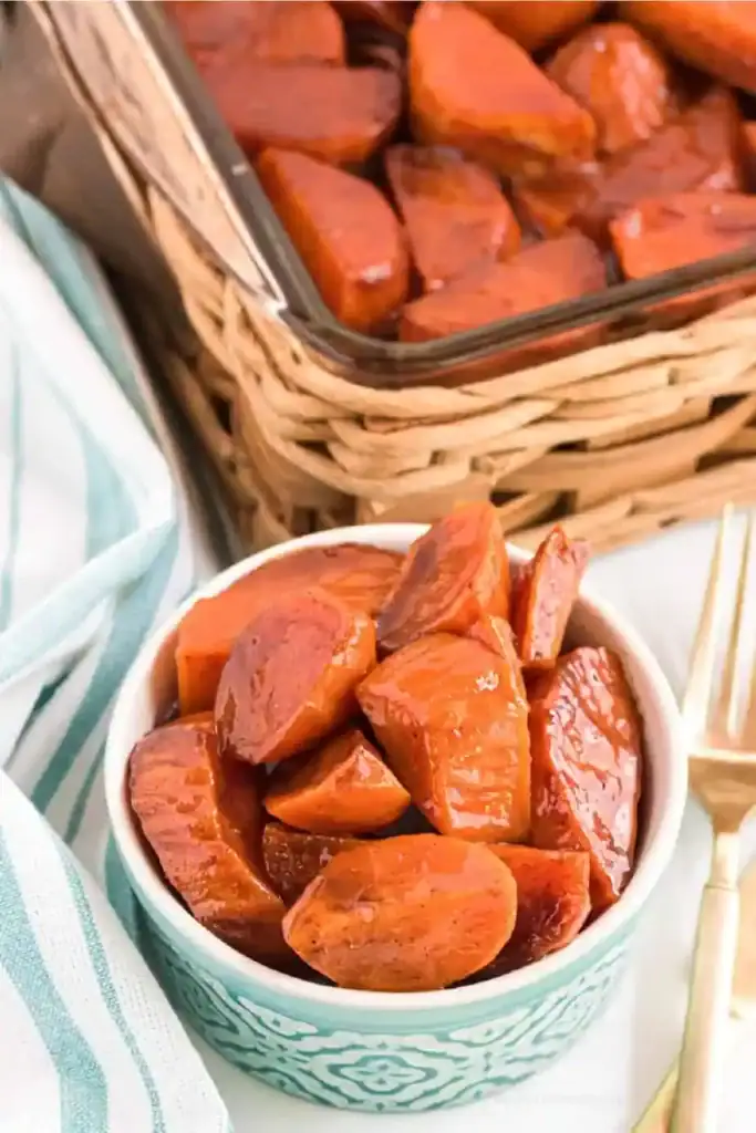 Baked candied yams in a bowl.