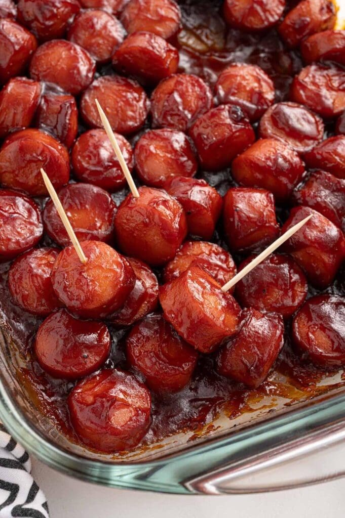 BBQ smoked sausage bites in a glass baking dish.