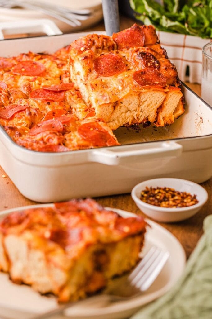 Bubble up pizza casserole with pepperoni and melted cheese in a baking dish.