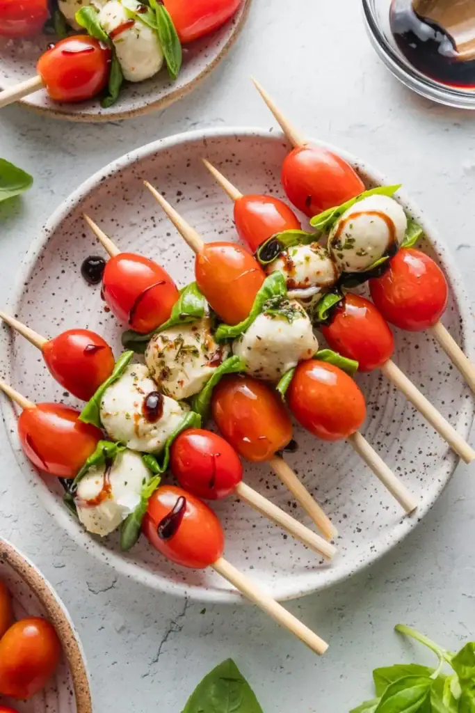 Caprese skewers on a plate.