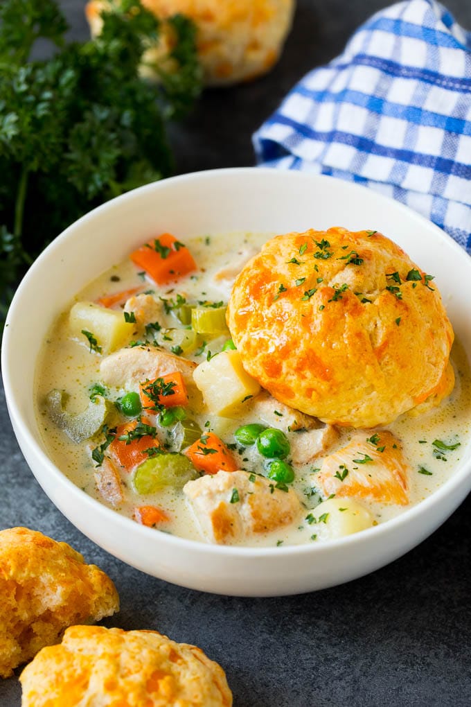 Chicken pot pie soup with a biscuit in a bowl.