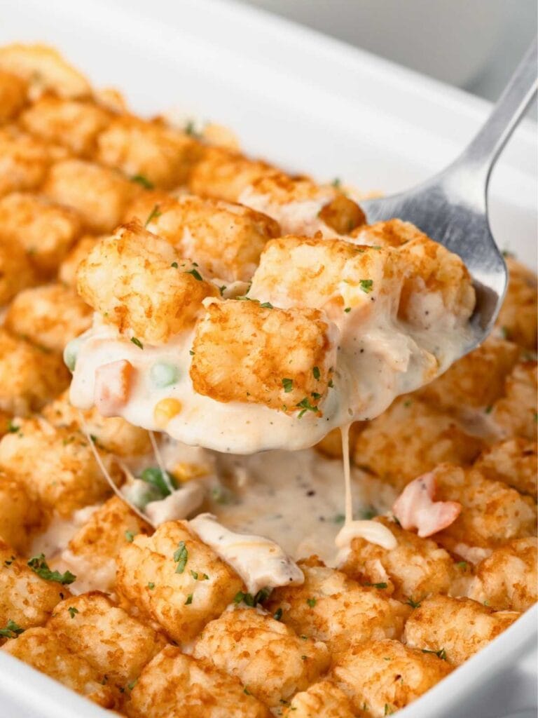 Chicken tater tot casserole on a spatula.