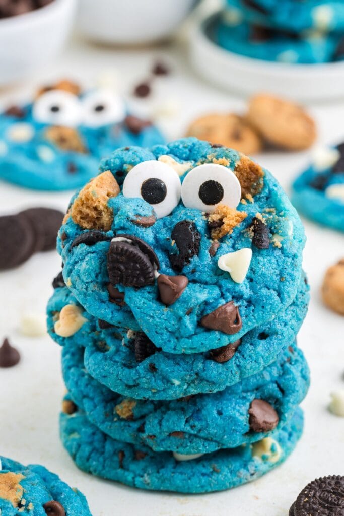 Stack of blue Cookie Monster cookies with chocolate chips and cookie pieces.