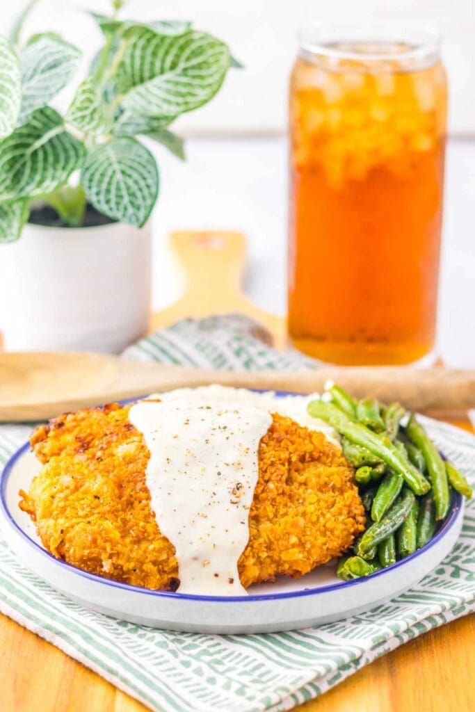 Copycat Cracker Barrel chicken fried steak with gravy on a plate.