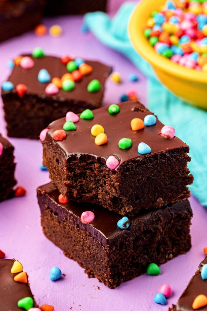 Chocolate cosmic brownies topped with colorful candy sprinkles.