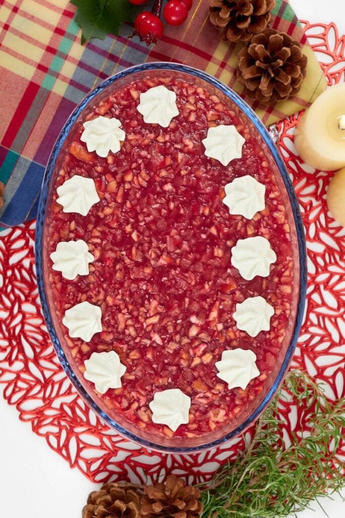 Cranberry Jello salad in an oblong glass bowl.