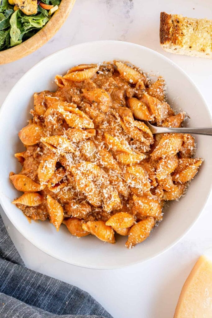 Creamy beef and shells in a bowl.