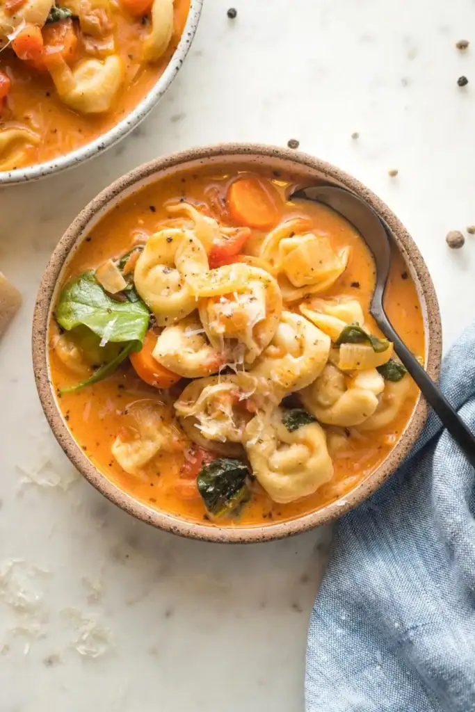 Creamy tomato tortellini soup in a bowl.
