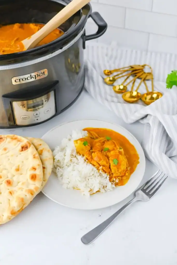 Crockpot butter chicken on a plate.