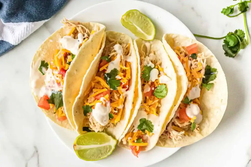 Crockpot shredded chicken tacos on a plate.